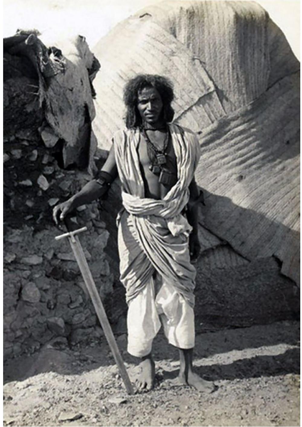 Very old image of an African man with his sword