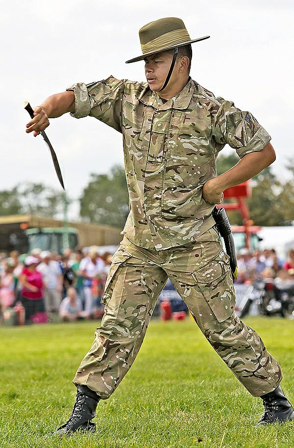 British Gurkha soldier performing traditional dance with khukuri knife, celebrating Nepalese culture and military spirit