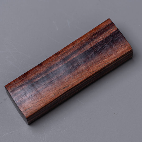 Rosewood handle — dense, dark-grained hardwood
