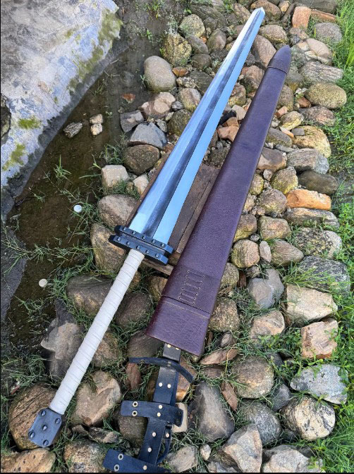 Hand-forged Guts Raider greatsword with riveted twin-plate guard, white leather wrap and brown leather scabbard