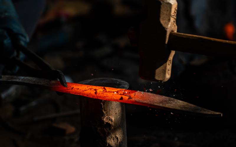 Initial forging at Everest Forge — blacksmith heating and hammer shaping 5160 high carbon steel blade in Kathmandu, Nepal