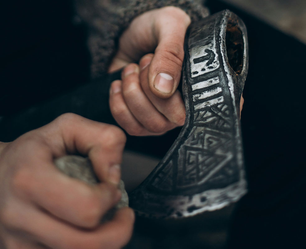 Sharpening the edge of a hand-forged axe head