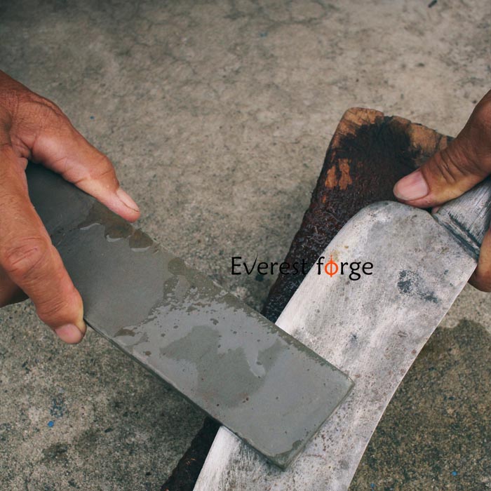Sharpening stone applied from above the knife to polish and refine edge