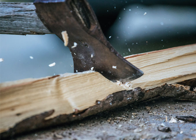 Axe chopping wood for outdoor and bushcraft use