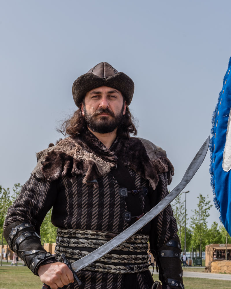 Man holding a curved sword