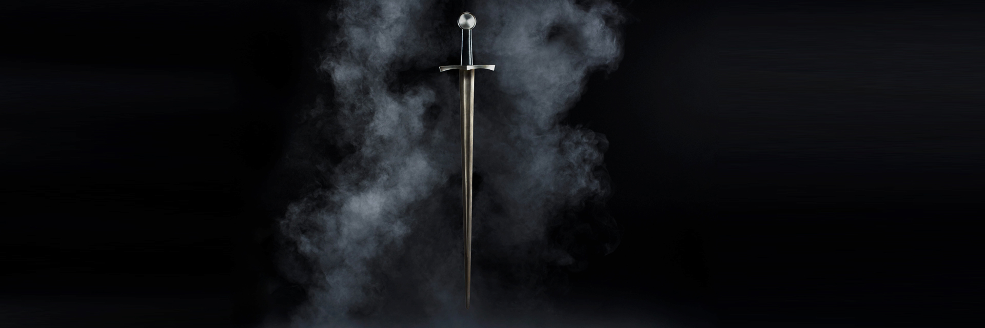 Hand-forged battle-ready medieval sword with wheel pommel against dark forge smoke, Everest Forge Nepal