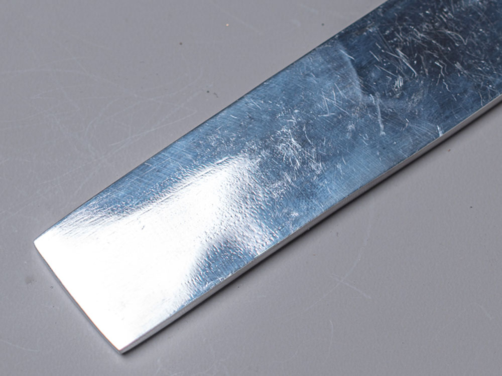 Polished mirror finish blade with a bright, reflective surface