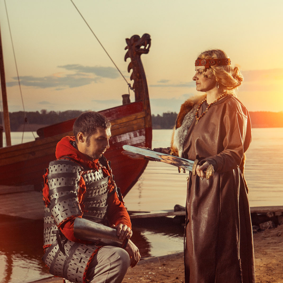 Art of a woman giving a sword as a gift to a warrior