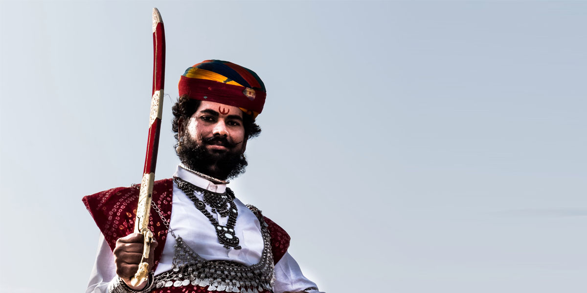 Indian man holding traditional sword showcasing historic Indian sword culture