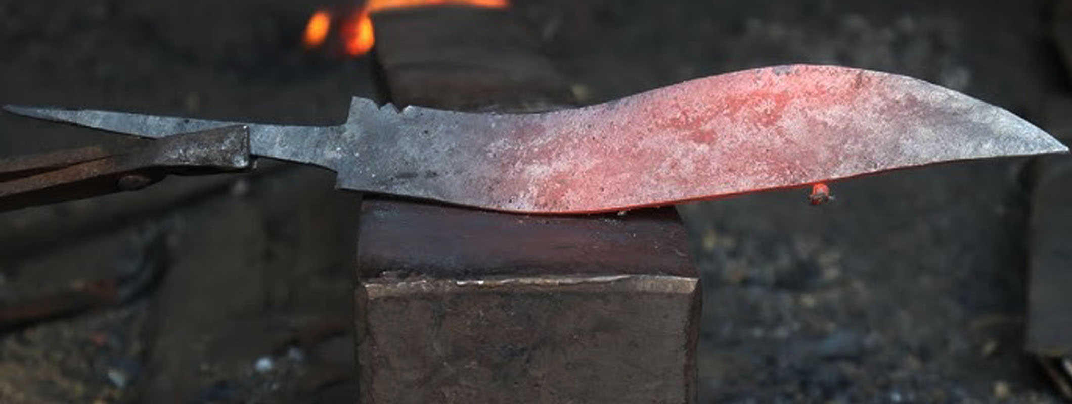 Hand-forged kukri in progress at a Nepalese forge during the shaping stage
