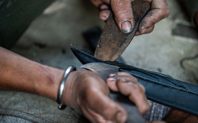 Handmade scabbard making at Everest Forge — crafting traditional wooden core leather scabbards and western leather sheaths for hand-forged blades in Kathmandu, Nepal