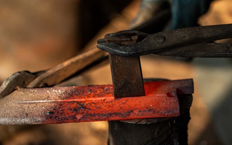 Steel preparation at Everest Forge — measuring and cutting 5160 high carbon steel billets before forging in Kathmandu, Nepal